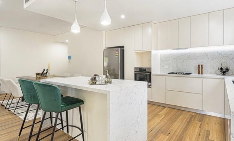 Blackbutt boards ground the crisp white kitchen