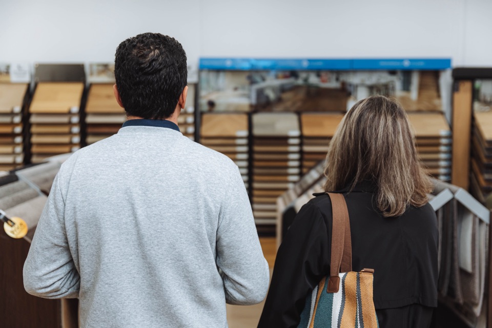 A couple weighs up the timber displays