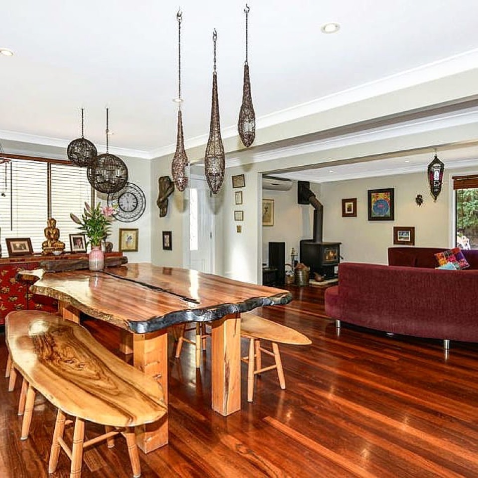 Jarrah glows beneath the timber slab table