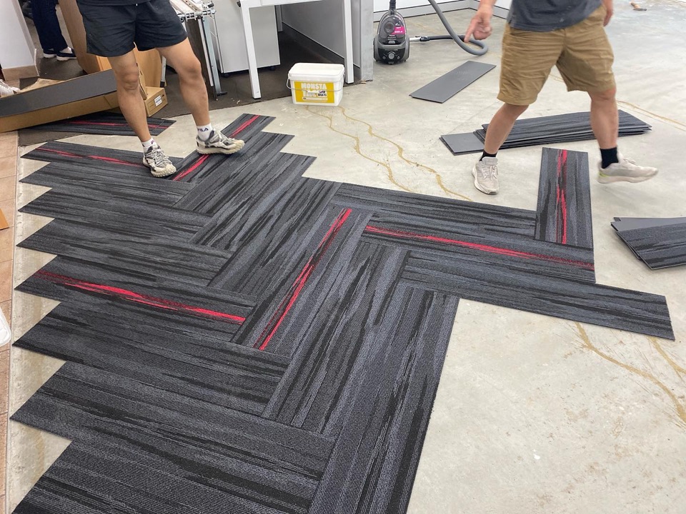 Herringbone carpet tiles taking shape over the slab