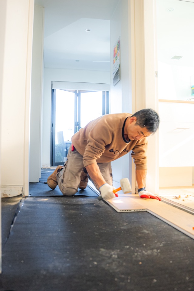 Tapping boards into place at the doorway