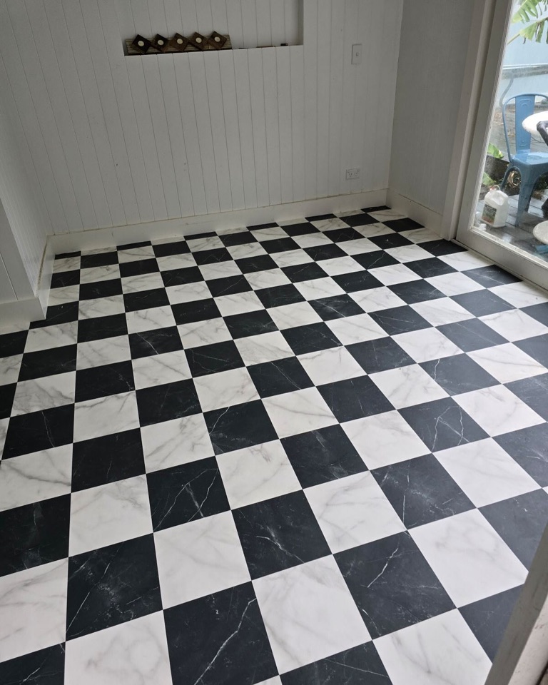 Chequerboard vinyl laid for the pool room