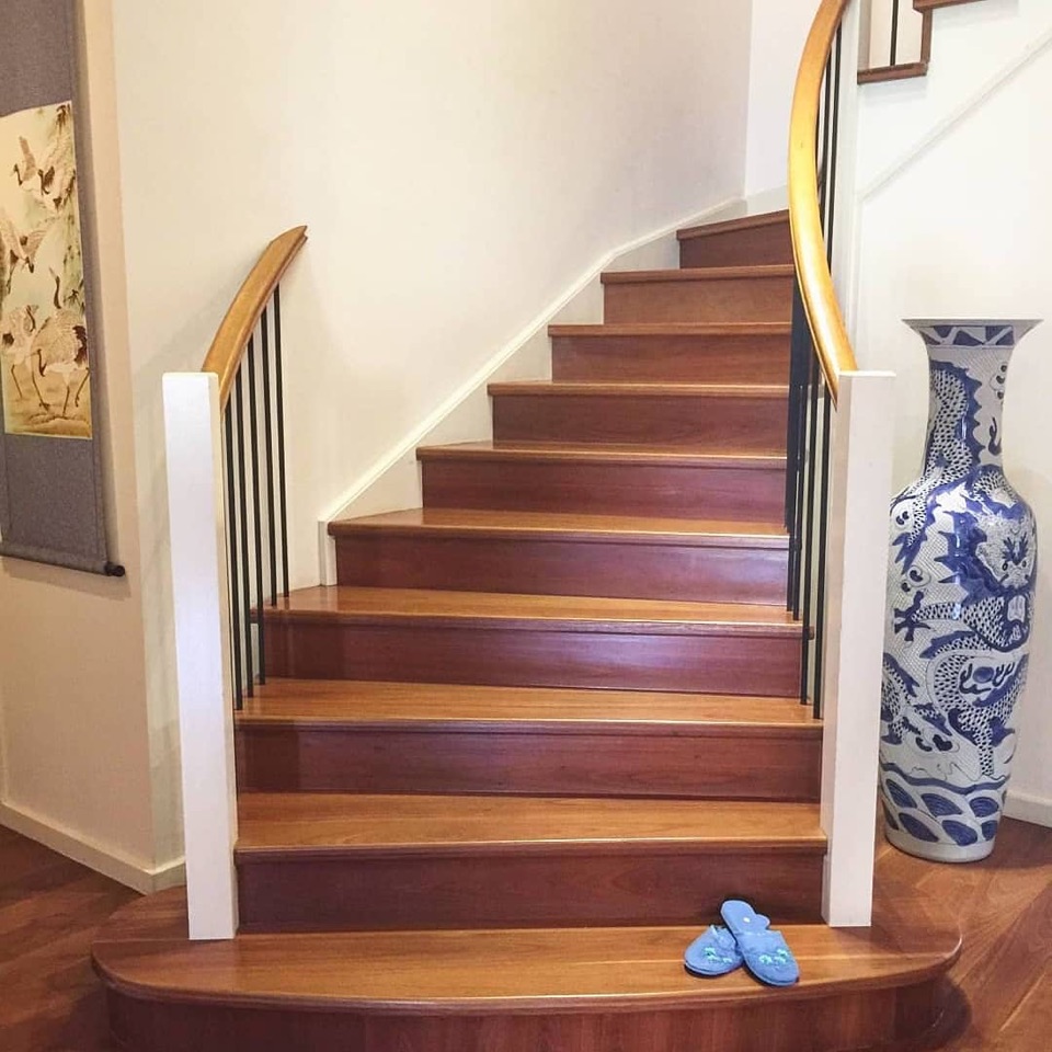 Red ironbark treads sweep up the curved staircase