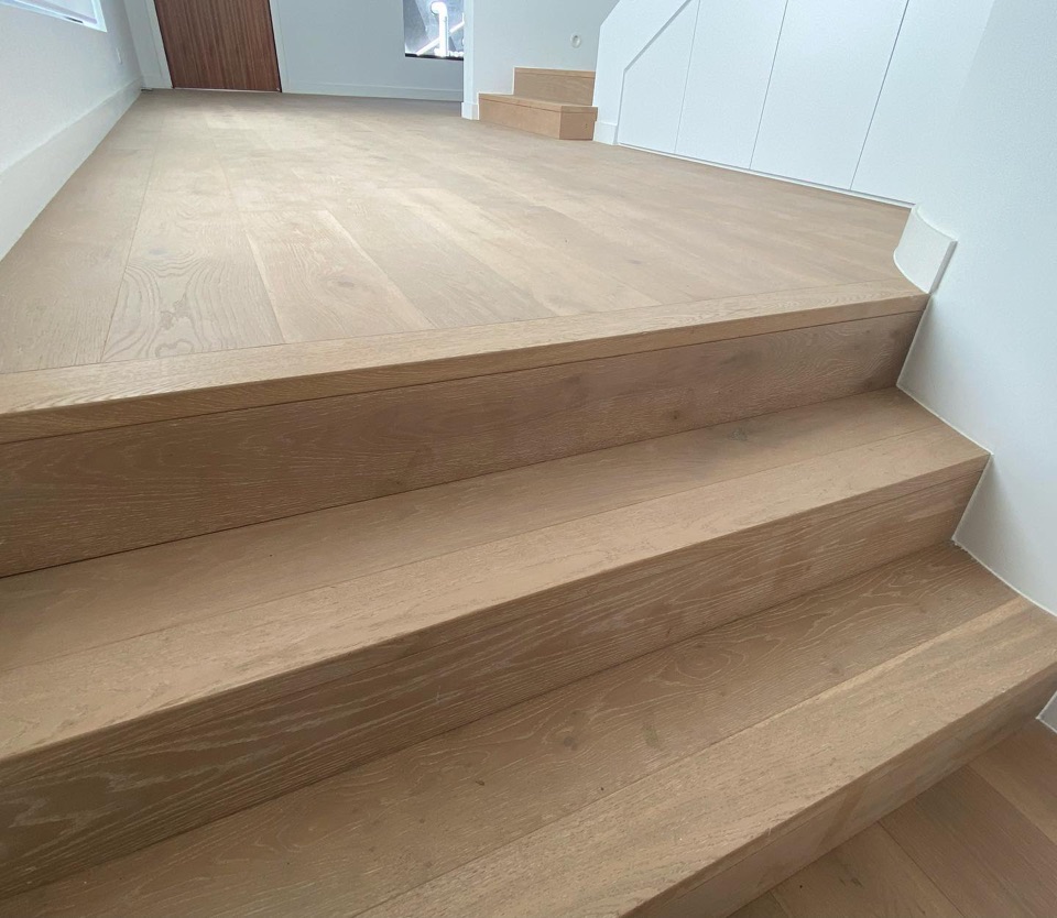 Wide oak treads step up to the landing