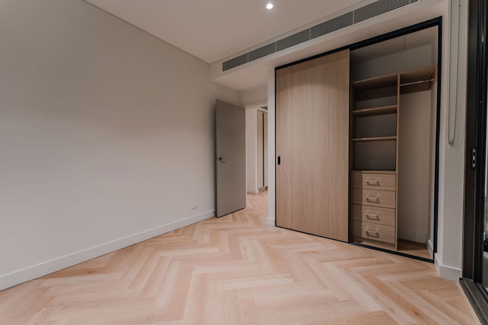Pale herringbone runs into the bedroom wardrobe