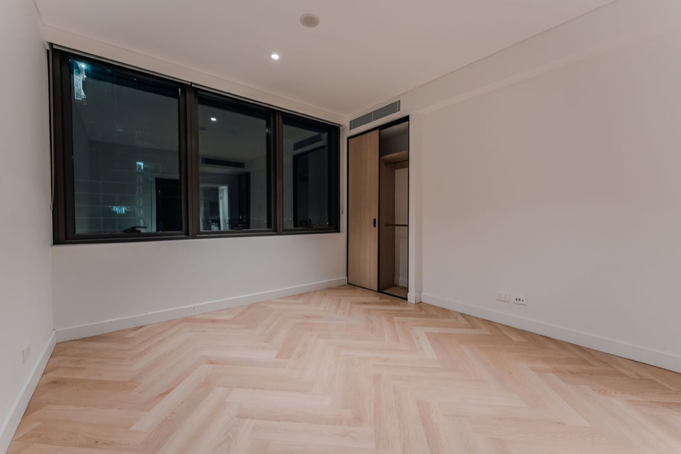 Bedroom herringbone under warm downlights