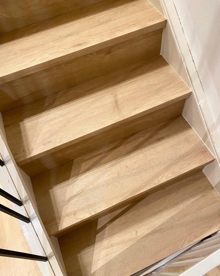 Warm oak hybrid wraps the winding staircase