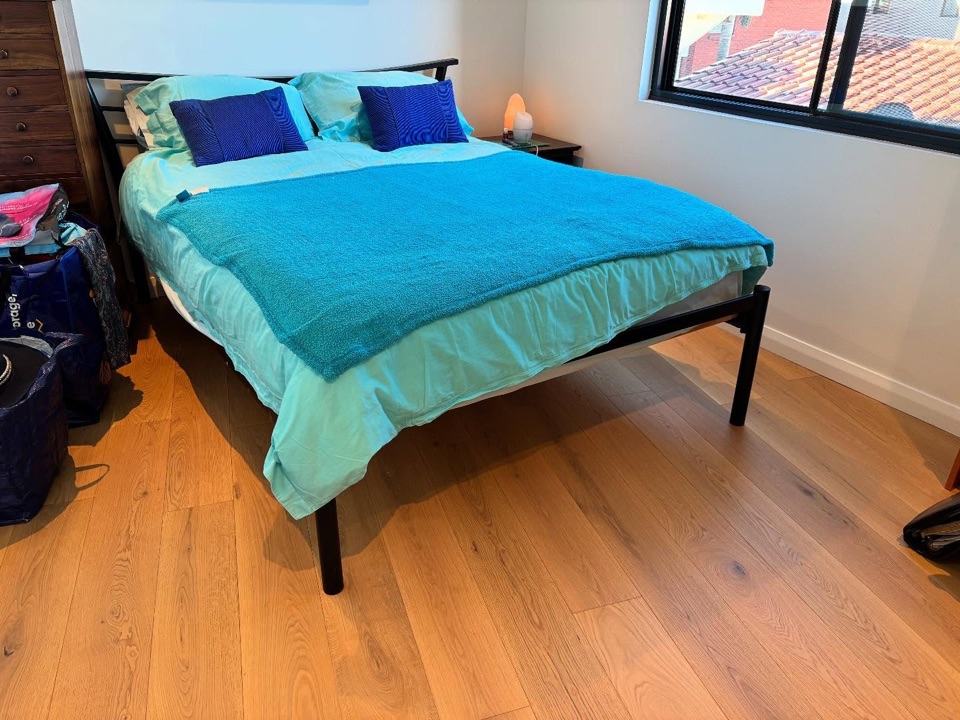 Oak boards bring warmth to the bedroom