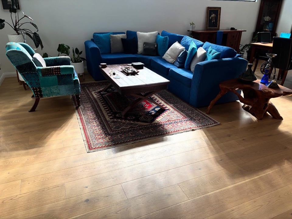 Wide oak boards anchor a colourful living room