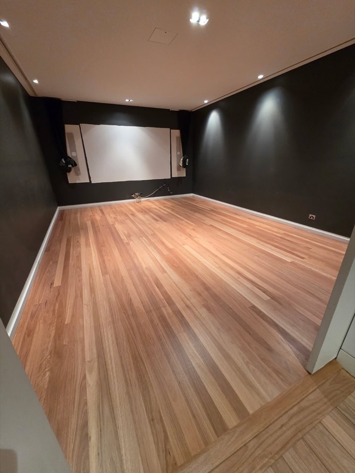Timber boards glowing against charcoal walls