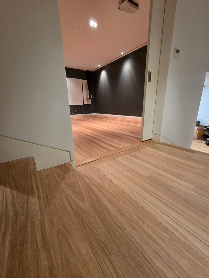Fresh oak boards flow from the hallway through the doorway