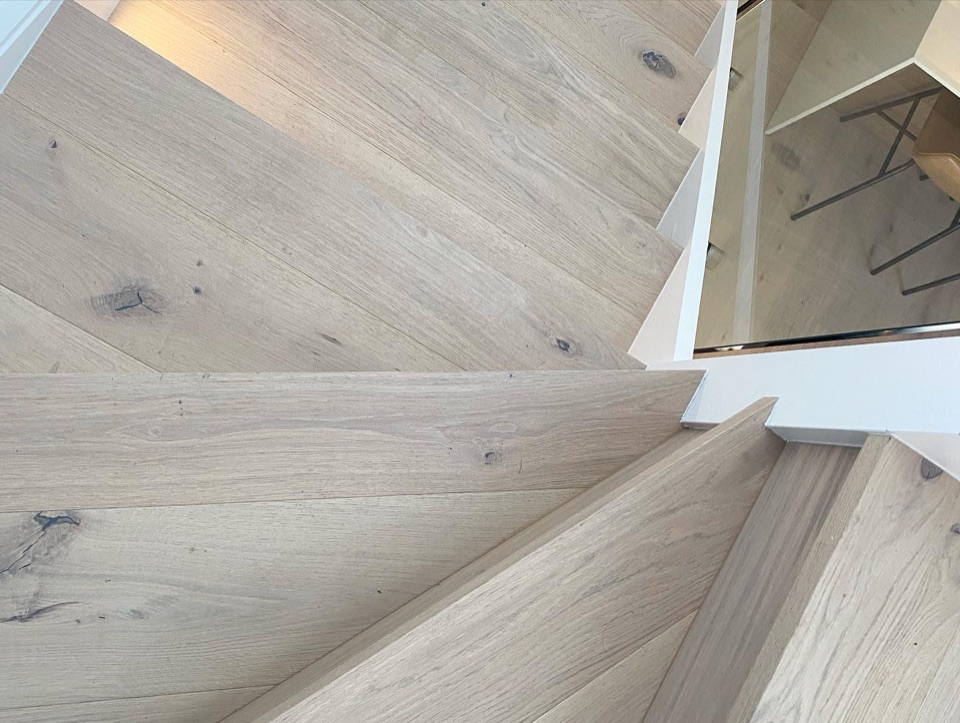 Looking down the pale oak winder stairs
