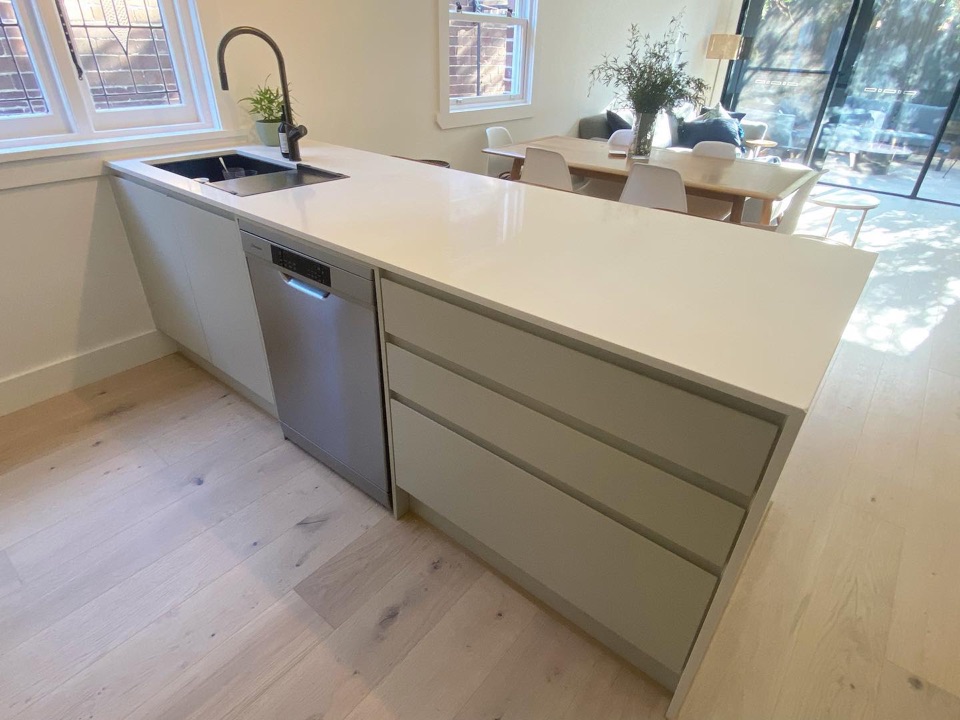 Pale oak wraps around the kitchen island