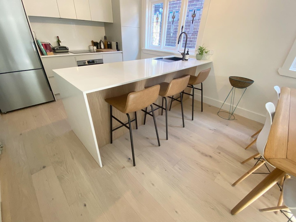 Pale oak boards around the island bench