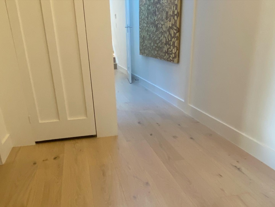 Light oak boards run down the hallway