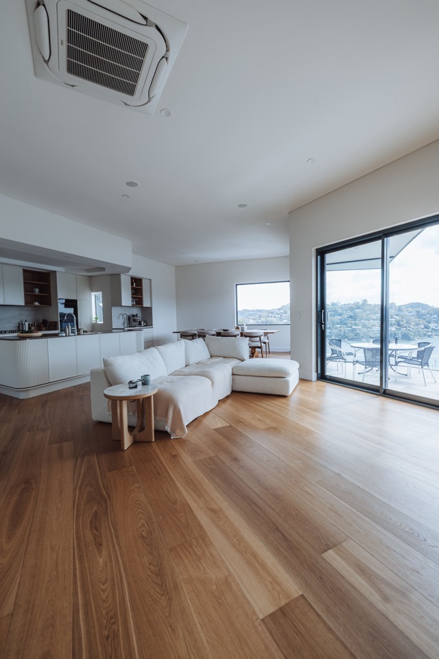 The boards run the length of the room towards the kitchen
