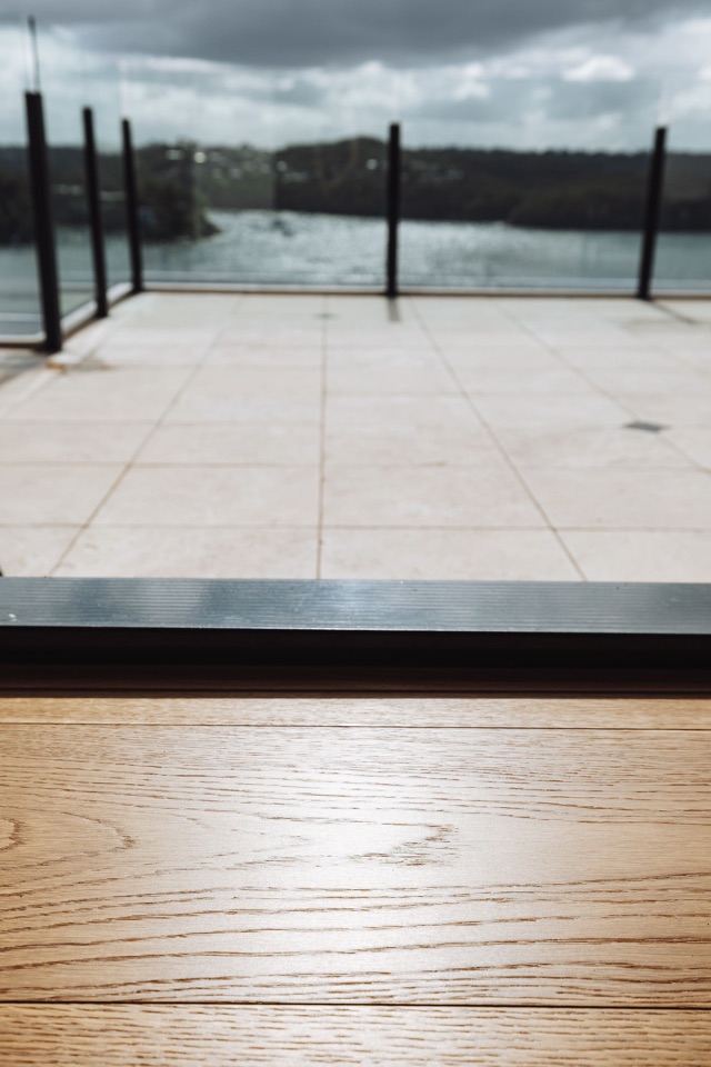 The floor running out to the terrace door, harbour outside