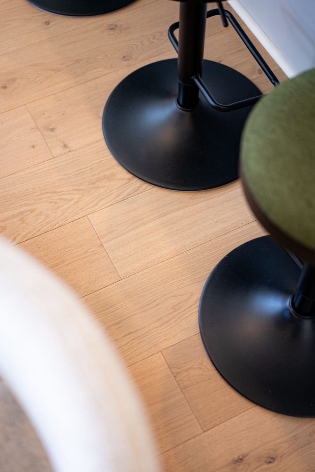 Pebble oak up close beneath the stools