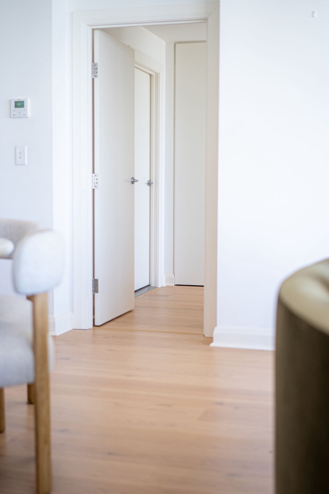 A peek down the hallway over pale oak