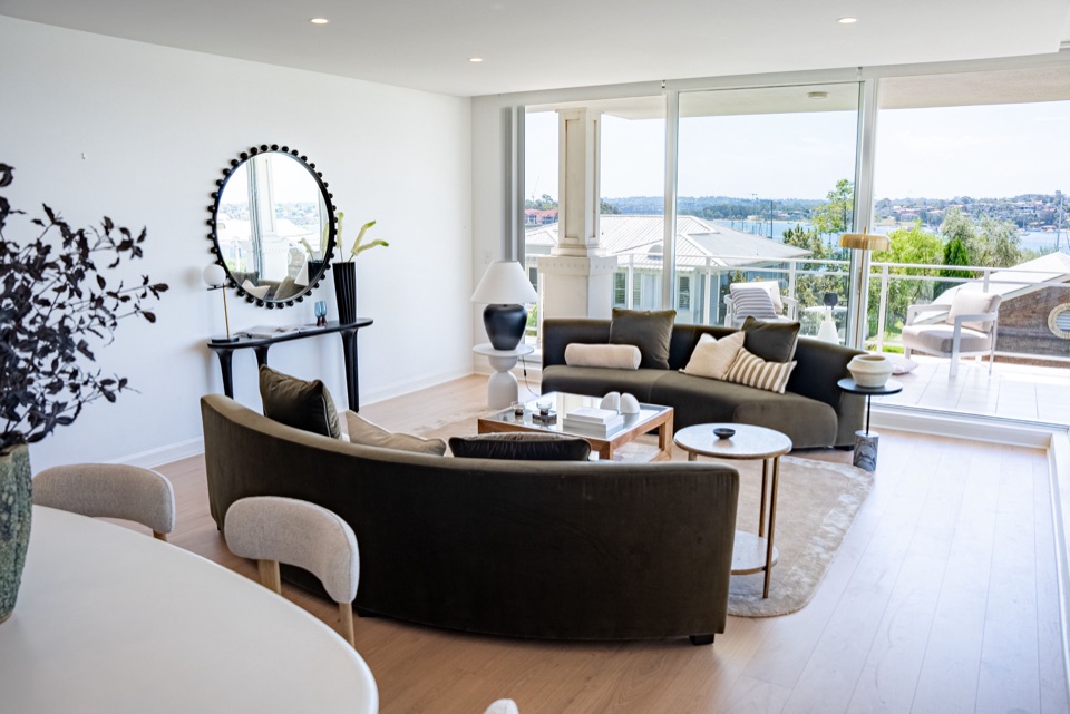 Pale oak living room with water views beyond