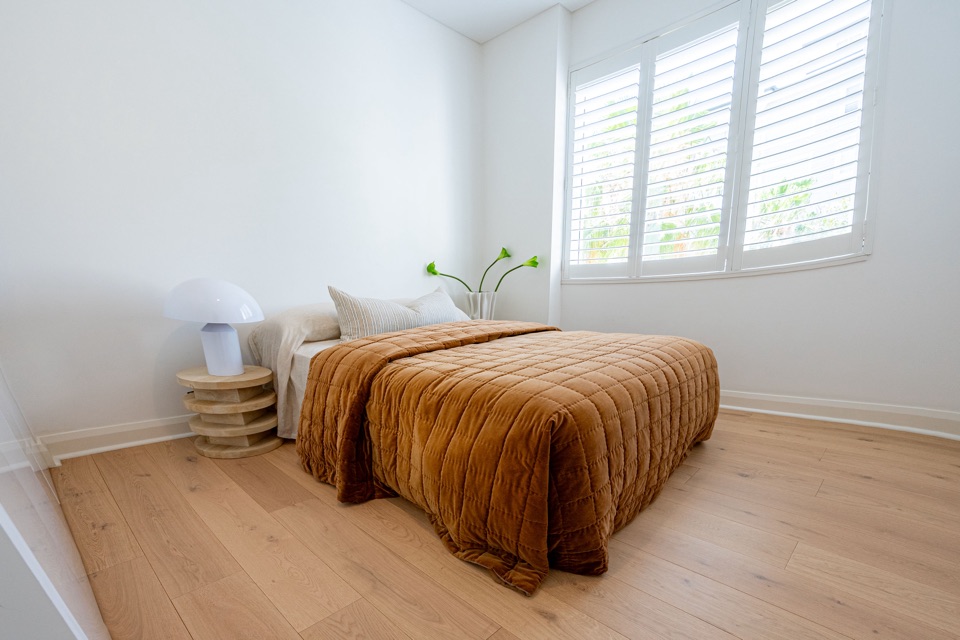 Plantation shutters and pebble oak in the bedroom