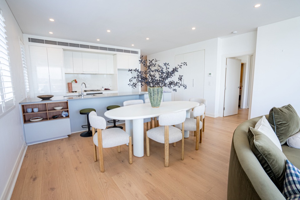 Dining space grounded in pale European oak
